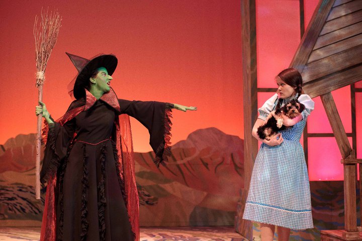 Laura Caswell as the Wicked Witch and Blair Irwin as Dorothy with Butch as Toto in the Wizard of Oz at Neptune Theatre